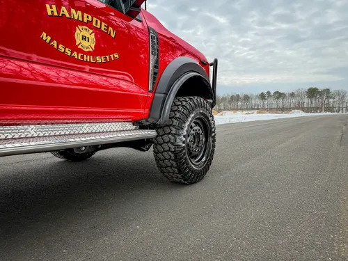 Lower driver-side body panel with Hampden department crest.